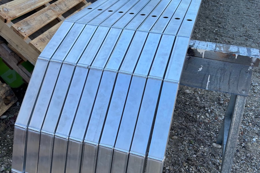 stack of custom aluminum rub rails for pontoons
